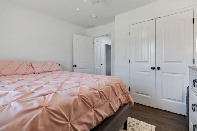 bedroom featuring a closet, ceiling fan, and dark hardwood / wood-style floors