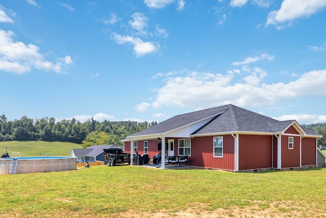 rear view of property with a patio area and a lawn