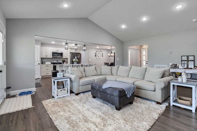 living room featuring a notable chandelier, high vaulted ceiling, and dark wood-type flooring