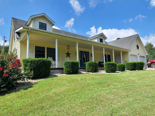 view of front facade featuring a front lawn, a garage, and a porch