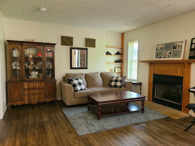 living room featuring dark hardwood / wood-style flooring and a textured ceiling