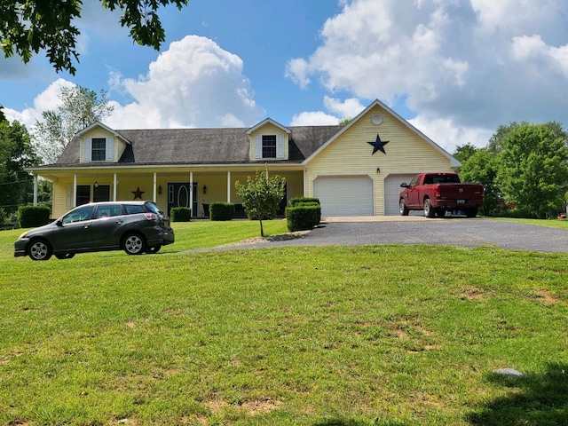 view of front of property with a front lawn and a garage