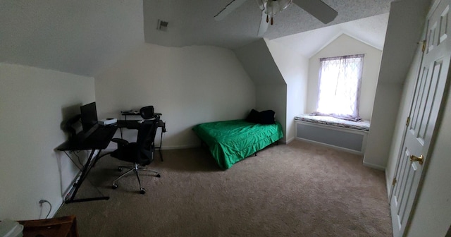 carpeted bedroom with ceiling fan, vaulted ceiling, and a textured ceiling