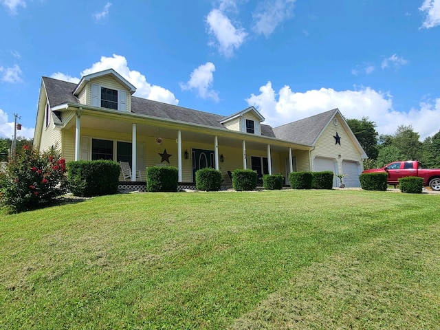 view of front facade with a porch, a garage, and a front yard