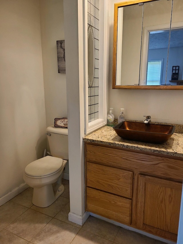 bathroom featuring vanity, tile patterned flooring, and toilet