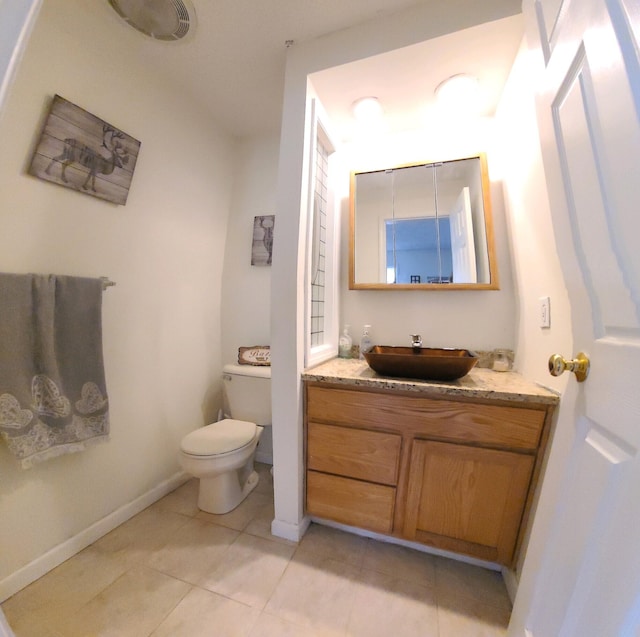 bathroom featuring vanity, toilet, and tile patterned flooring