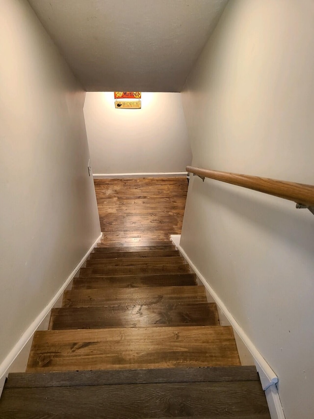 stairs with wood-type flooring