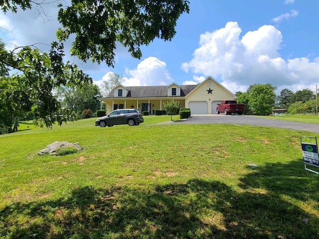 view of front of house with a garage and a front lawn