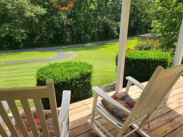 wooden deck featuring a lawn