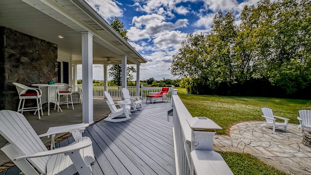 wooden deck featuring a patio and a yard