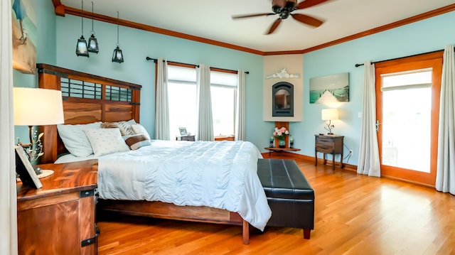 bedroom featuring ceiling fan, ornamental molding, and light hardwood / wood-style floors