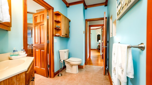 bathroom with vanity, toilet, hardwood / wood-style floors, and ornamental molding