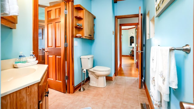 bathroom with vanity, tile patterned flooring, and toilet