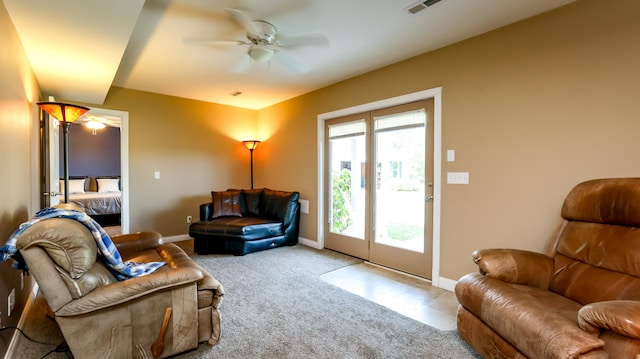 living room featuring ceiling fan and light colored carpet