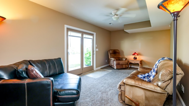 carpeted living room featuring ceiling fan