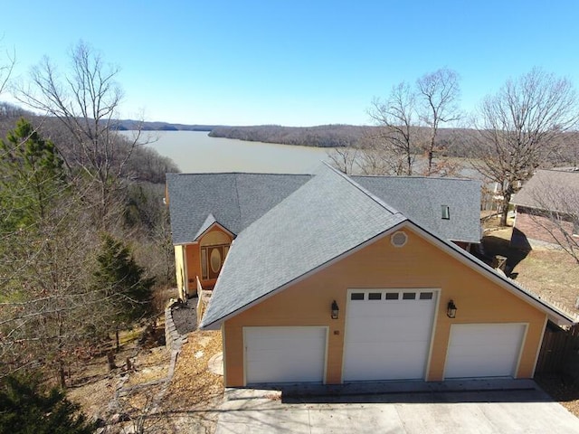 view of front facade with a garage and a water view