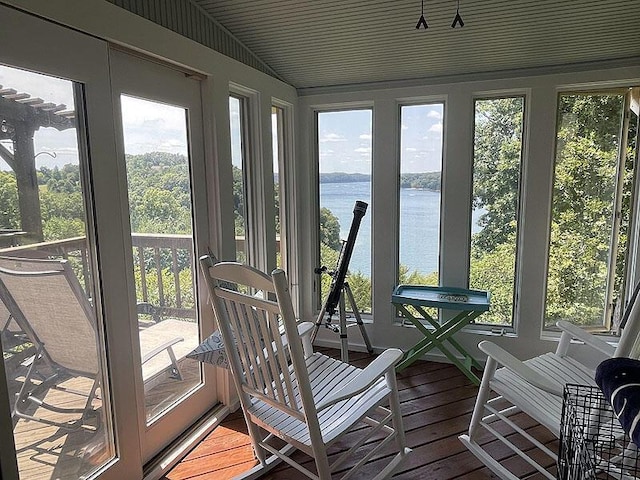 sunroom / solarium with a water view