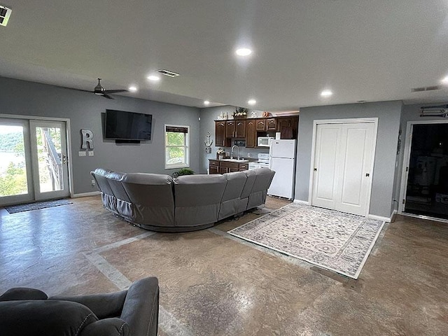 living room with baseboards, visible vents, and recessed lighting