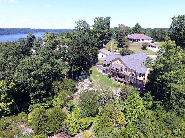 drone / aerial view with a water view and a wooded view