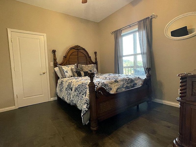 bedroom featuring ceiling fan, baseboards, and dark wood-type flooring