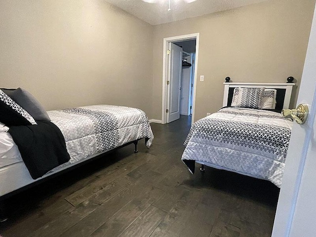 bedroom featuring baseboards and wood finished floors