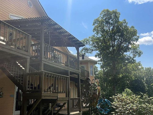 view of side of home featuring stairway and a pergola