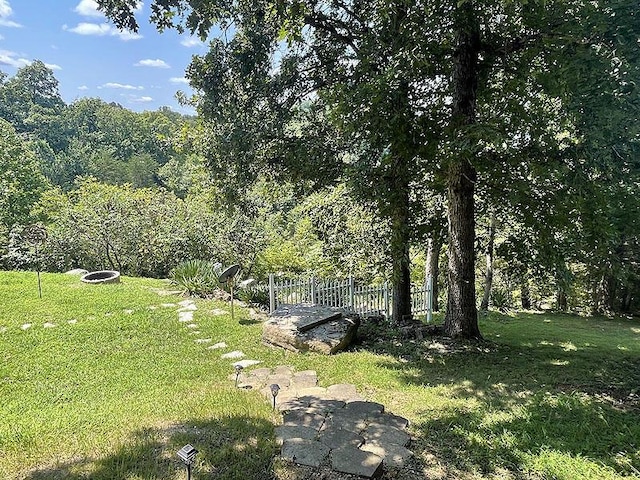 view of yard featuring a forest view