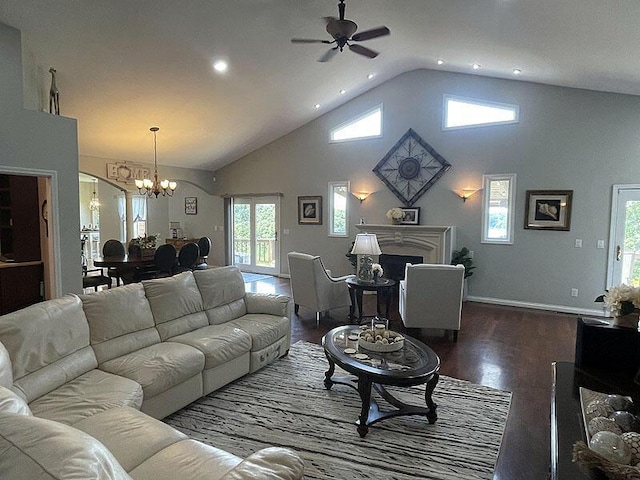 living room featuring high vaulted ceiling, recessed lighting, ceiling fan with notable chandelier, baseboards, and dark wood finished floors