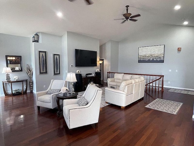 living area featuring lofted ceiling, ceiling fan, baseboards, and wood finished floors