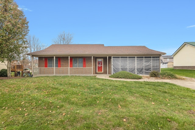 single story home featuring a sunroom and a front yard