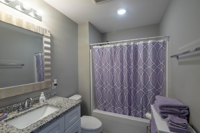 full bathroom with vanity, shower / bath combination with curtain, and toilet