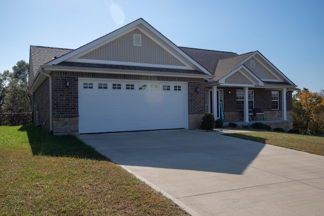 view of front of house with a garage, a front lawn, and a porch