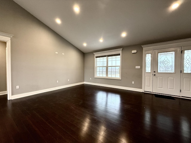 foyer featuring vaulted ceiling and dark hardwood / wood-style flooring