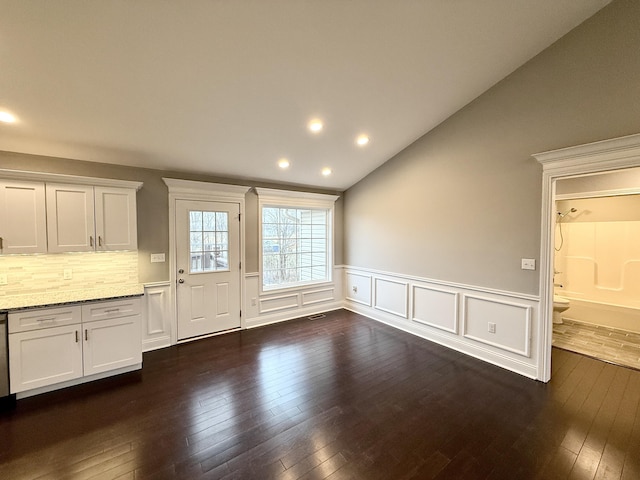 interior space with dark hardwood / wood-style flooring and lofted ceiling