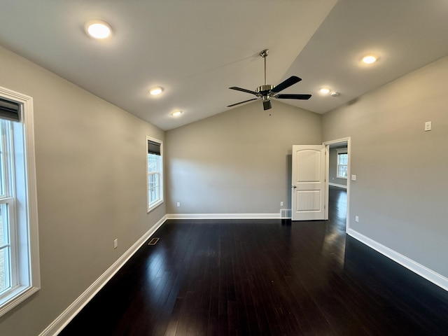 unfurnished room with vaulted ceiling, ceiling fan, and dark hardwood / wood-style flooring