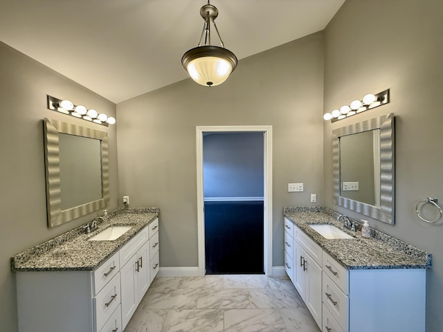 bathroom featuring vanity and lofted ceiling