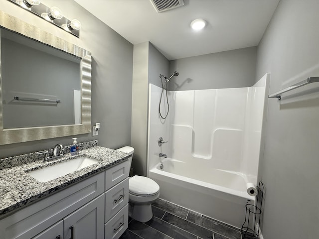 full bathroom featuring vanity, tub / shower combination, and toilet