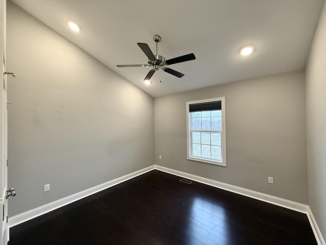 unfurnished room with dark wood-type flooring and ceiling fan