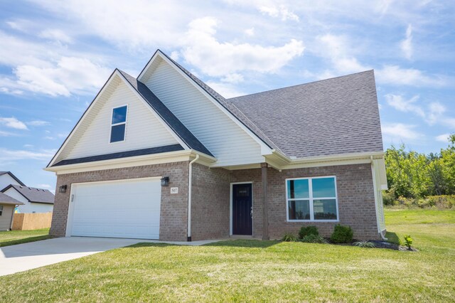 view of front of home with a garage and a front lawn