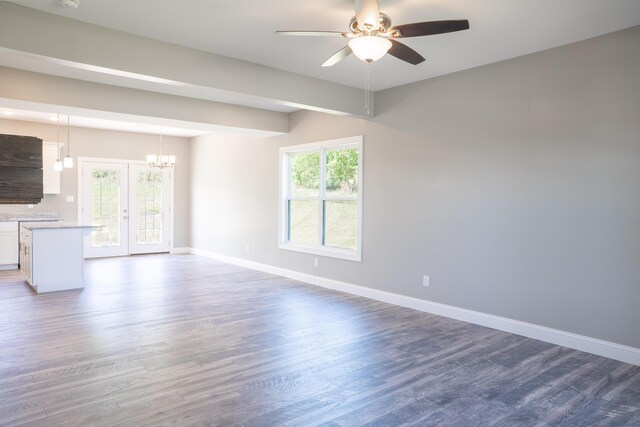 unfurnished living room featuring dark wood-type flooring, ceiling fan, and french doors