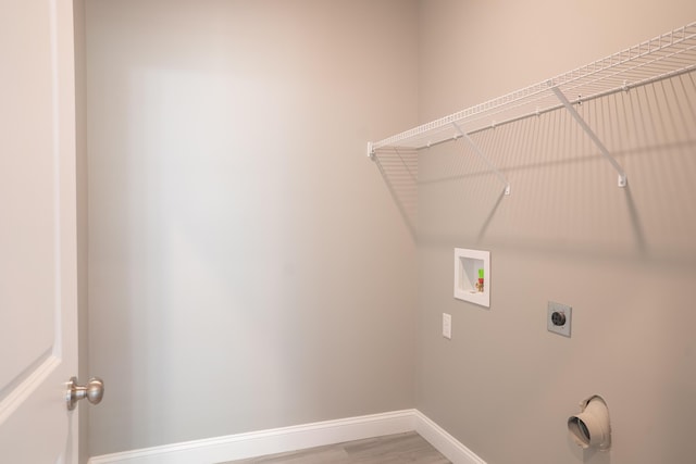 laundry area with wood-type flooring, hookup for an electric dryer, and hookup for a washing machine