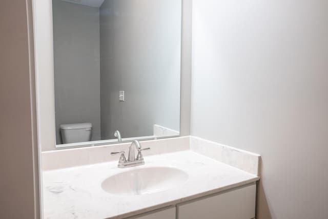 bathroom featuring vanity and toilet