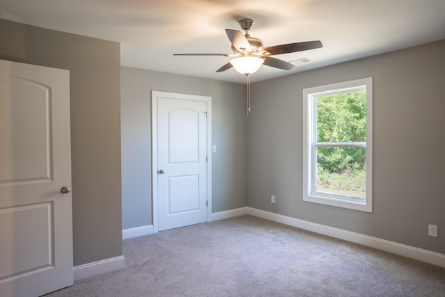 unfurnished bedroom featuring light carpet and ceiling fan