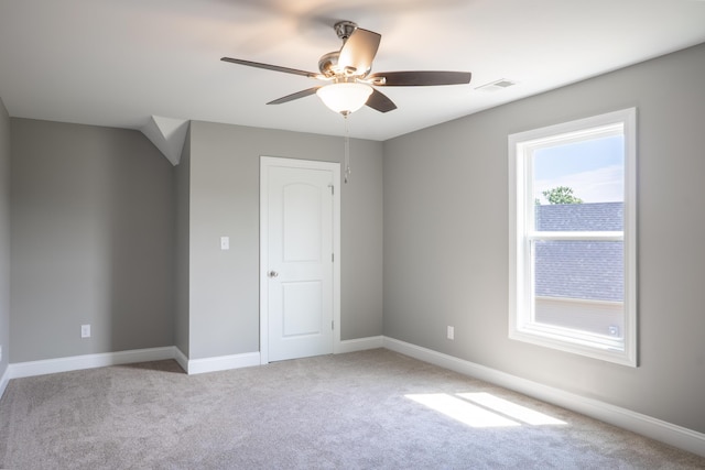 unfurnished bedroom featuring light carpet and ceiling fan