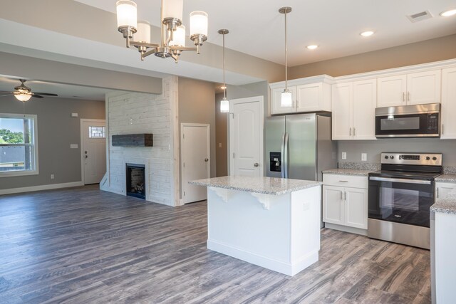 kitchen with white cabinetry, appliances with stainless steel finishes, and hanging light fixtures