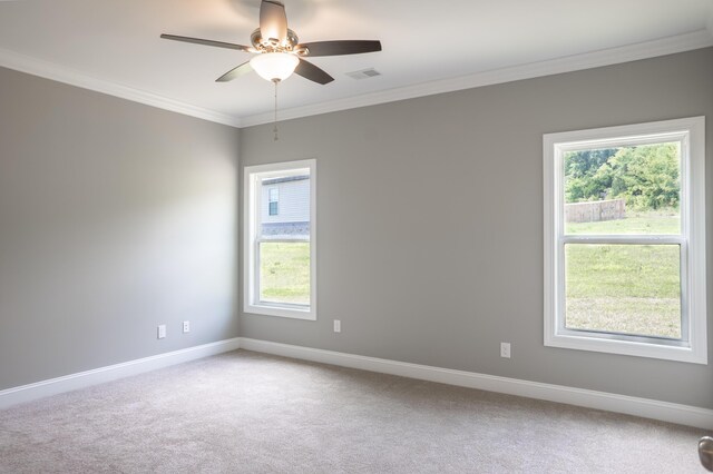 spare room with carpet floors, ornamental molding, and ceiling fan