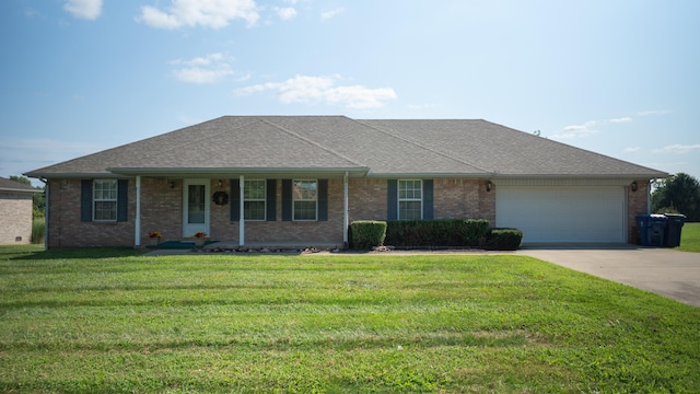 ranch-style house featuring a front lawn, covered porch, and a garage