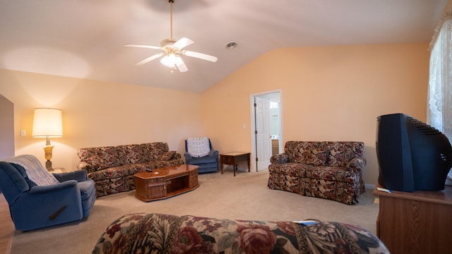 carpeted living room with ceiling fan and vaulted ceiling