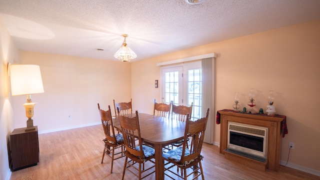 dining area featuring a textured ceiling and hardwood / wood-style flooring