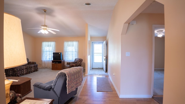 living room with ceiling fan, carpet, and a healthy amount of sunlight